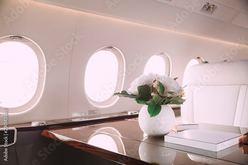 modern and comfortable interior of business jet aircraft with decor