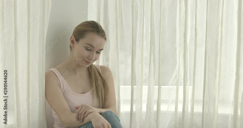 Young cheerful woman is smiling to camera in home interior. Friendly and positive. Copy space. Young cheerful woman is smiling to camera in home interior. Friendly and positive. Copy space.