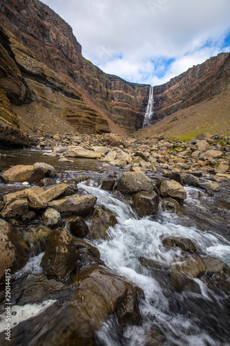 The beautiful Hengifoss hull seen along the river. Iceland  vertical photo