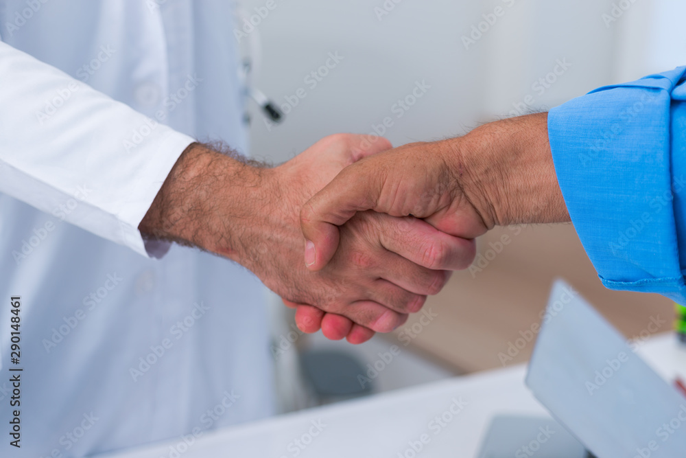 Handshake between a doctor and his senior ( old ) patient. Handshake between a doctor and his senior ( old ) patient.