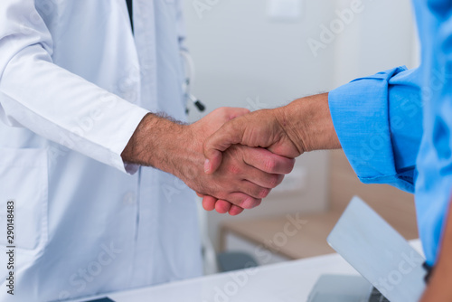 Handshake between a doctor and his senior ( old ) patient. © qunica.com