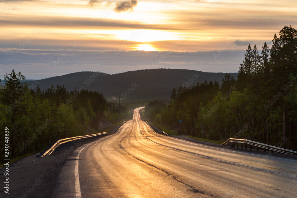 Fototapeta premium Asphalt road to mountain on sunset. Picturesque landscape scene.