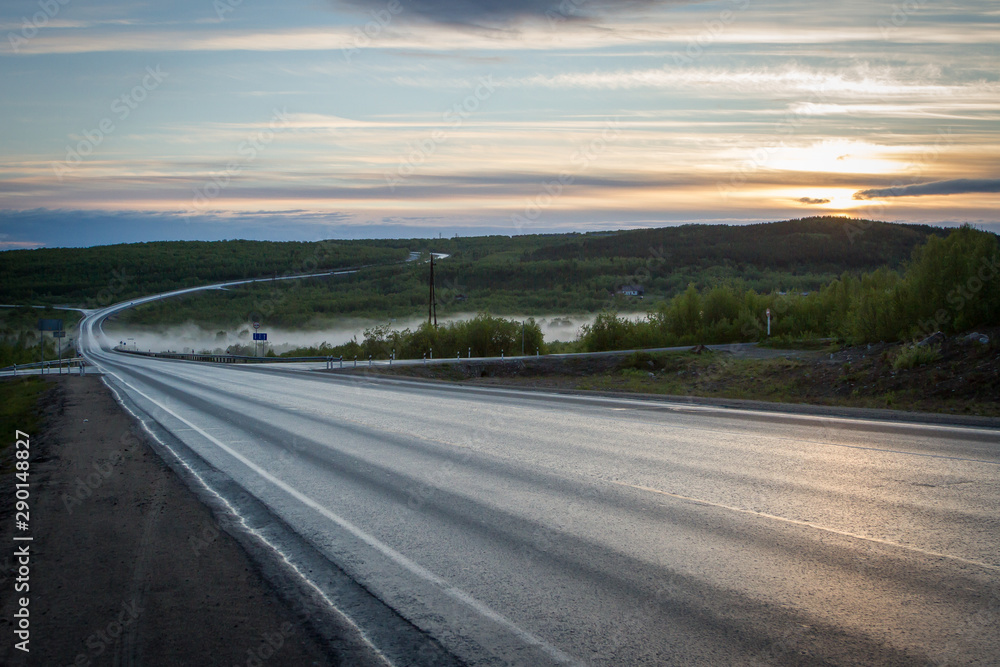 Fototapeta premium Asphalt road with fog on sunset.