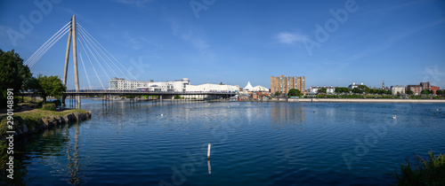 Looking northwards over the artificial lake from the ornate bridge in King's Gardens. Bridge that crosses the lake between Southport Town Centre and the Ocean Plaza on the seafront. photo