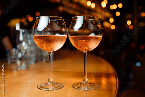 Two glasses of wine at the bar in a restaurant.