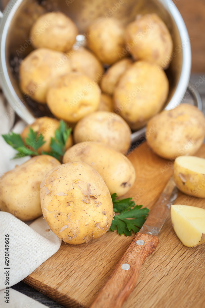 Raw potato. Fresh new potatoes on wooden background Raw potato. Fresh new potatoes on wooden background