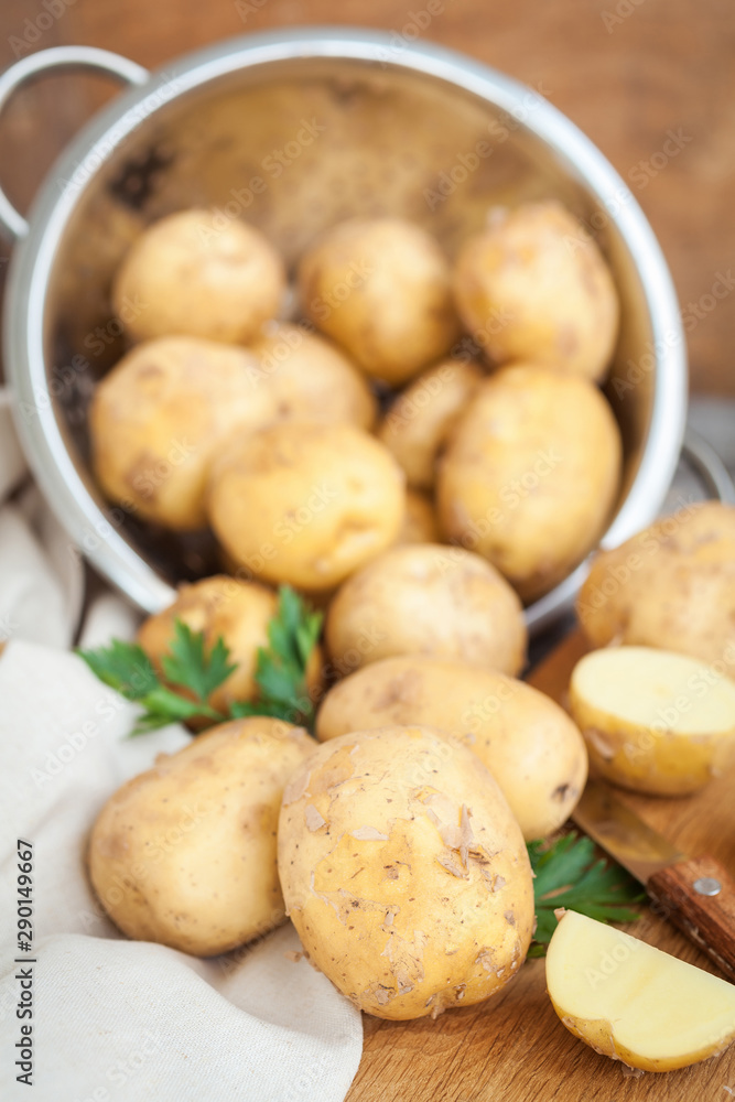 Raw potato. Fresh new potatoes on wooden background Raw potato. Fresh new potatoes on wooden background