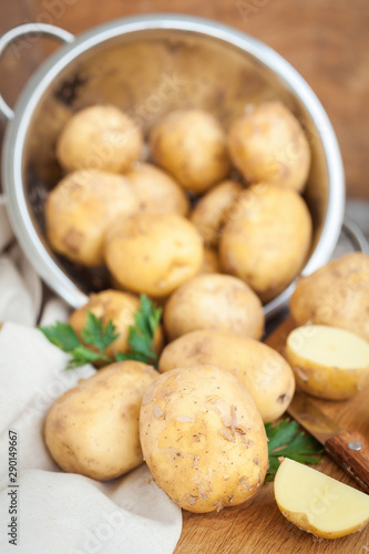 Raw potato. Fresh new potatoes on wooden background