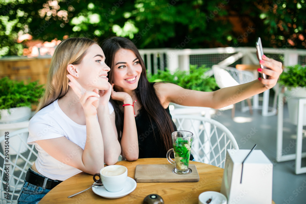 two beautiful young women talking on video call on phone two beautiful young women talking on video call on phone