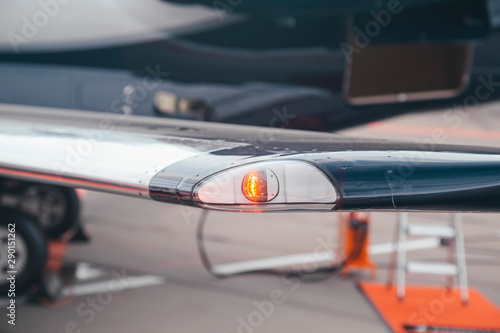 navigation light on the wing of jet airplane in airport