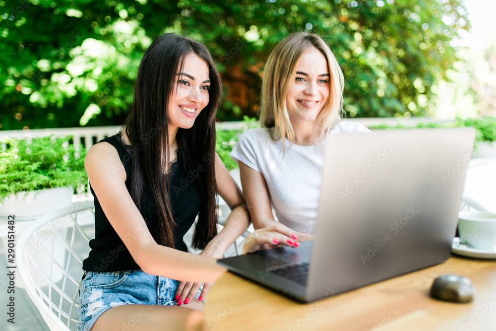 Glad women hug and pose at camera of laptop computer, make video call and speak with friends, share impessions to have holidays abroad in tropical country. People, rest and positive emotions Glad women hug and pose at camera of laptop computer, make video call and speak with friends, share impessions to have holidays abroad in tropical country. People, rest and positive emotions