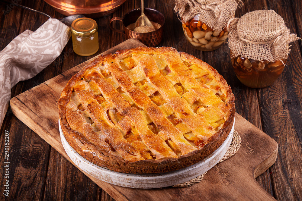 Homemade sweet pie cake with peach on white board on wooden rustic background Homemade sweet pie cake with peach on white board on wooden rustic background