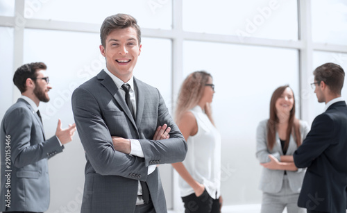 smiling young businessman standing in office.