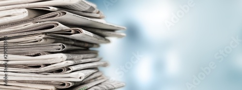 Fotografia Pile of newspapers on white background