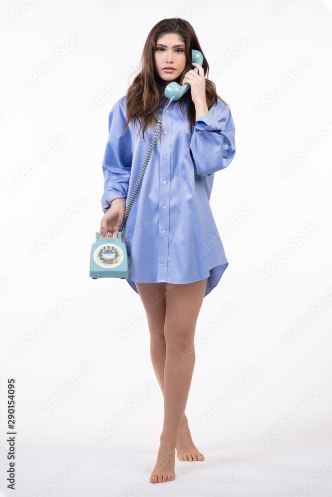 Fototapeta premium Beautiful Hispanic teen girl talking on vintage phone