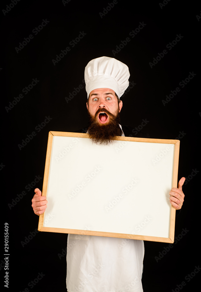 Chef menu. Man cook show empty menu chalkboard with copy space. Empty menu chalkboard with copy space for text. Male chef, cook or baker with blank board. Serious chef holds blackboard. Advertisement. Chef menu. Man cook show empty menu chalkboard with copy space. Empty menu chalkboard with copy space for text. Male chef, cook or baker with blank board. Serious chef holds blackboard. Advertisement.