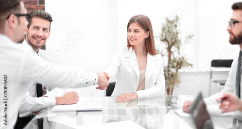 handshake business people in a modern office