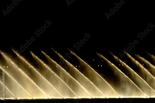 diagonal water fountains from Bellagio water games in Las Vegas against black background