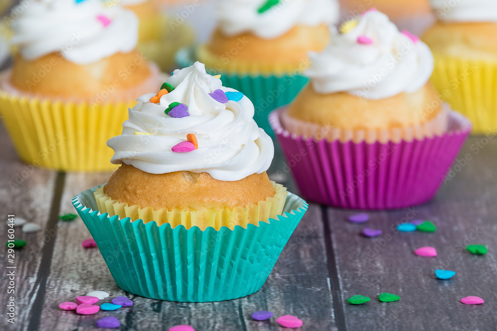 Colorful cupcakes decorated with heart shaped sprinkles