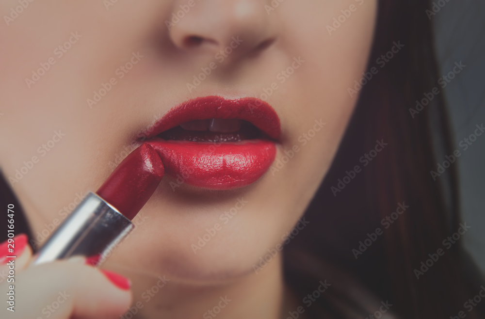 Naklejka premium Professional Make-up. Applying red liptick