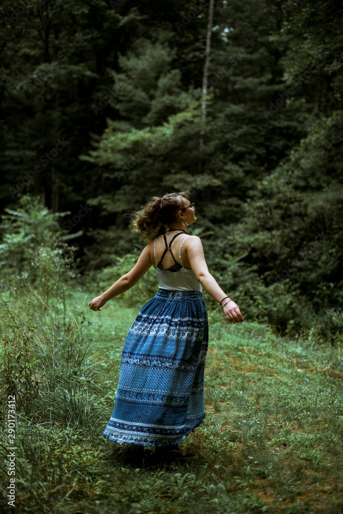 Young woman outdoors in long blue skirt Young woman outdoors in long blue skirt