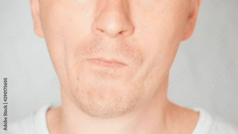 lower face caucasian male eats lunch portrait guy bites and chews lower face caucasian male eats lunch portrait guy bites and chews