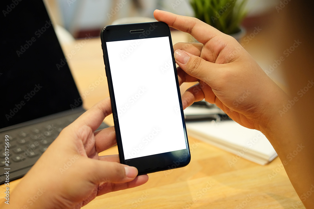 Cropped shot view of man hands holding smart phone with blank copy space screen for your text message or information content, female reading text message on cell telephone during in urban setting. Cropped shot view of man hands holding smart phone with blank copy space screen for your text message or information content, female reading text message on cell telephone during in urban setting.