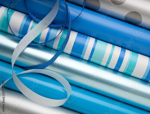 Fotografi Blue, silver and white wrapping paper gift wrap and ribbons for Hanukkah Chanuka
