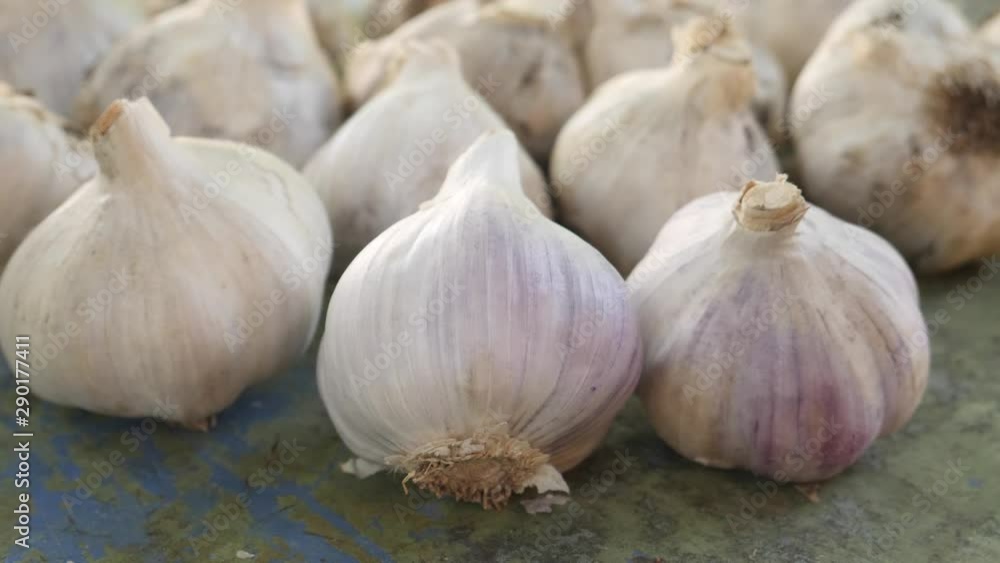 Fresh raw white garlic with segments on wooden background Fresh raw white garlic with segments on wooden background
