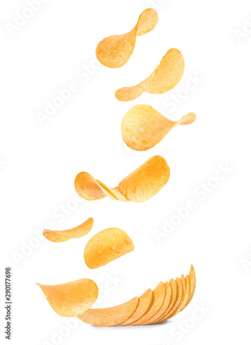 Falling crispy potato chips on white background