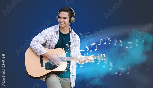 Young man playing guitar ou...