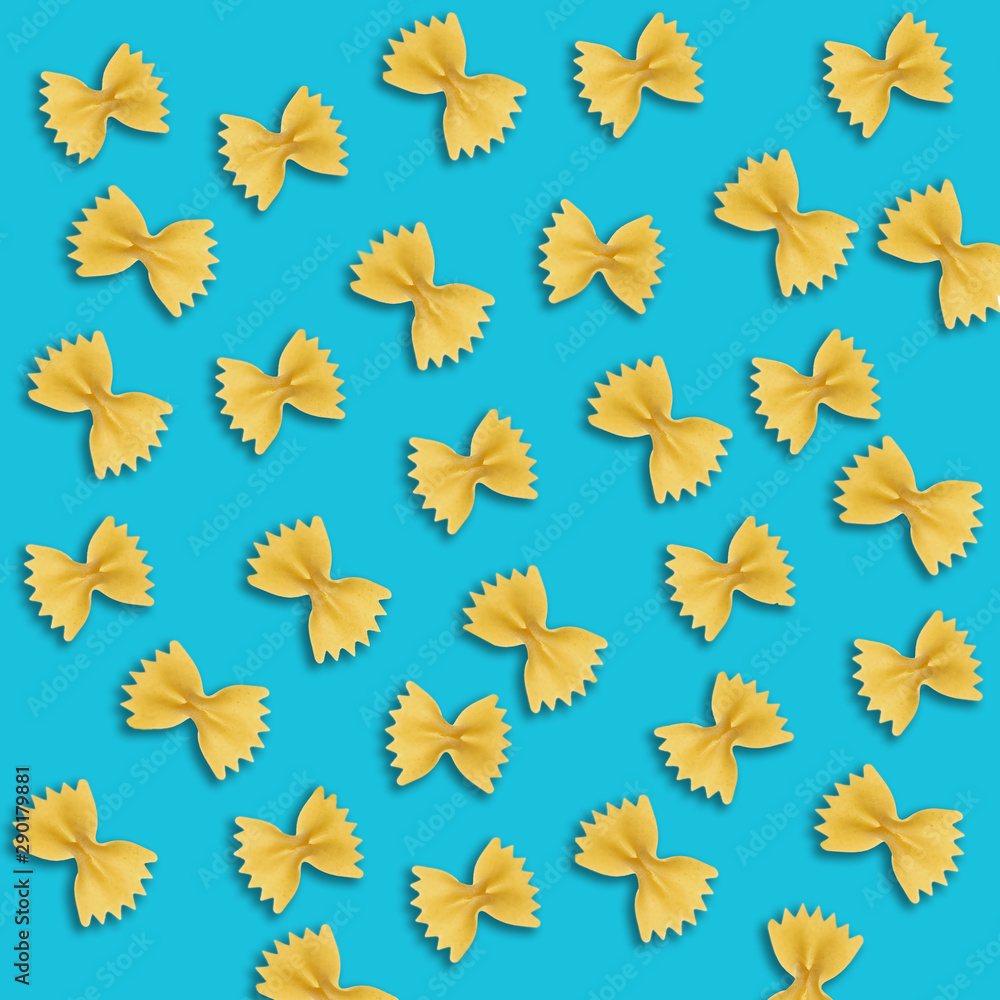 Fototapeta premium Uncooked farfalle pasta on color background