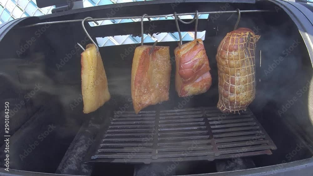 Home cooking Smoking pork ham and salted pork fat in small gas grill