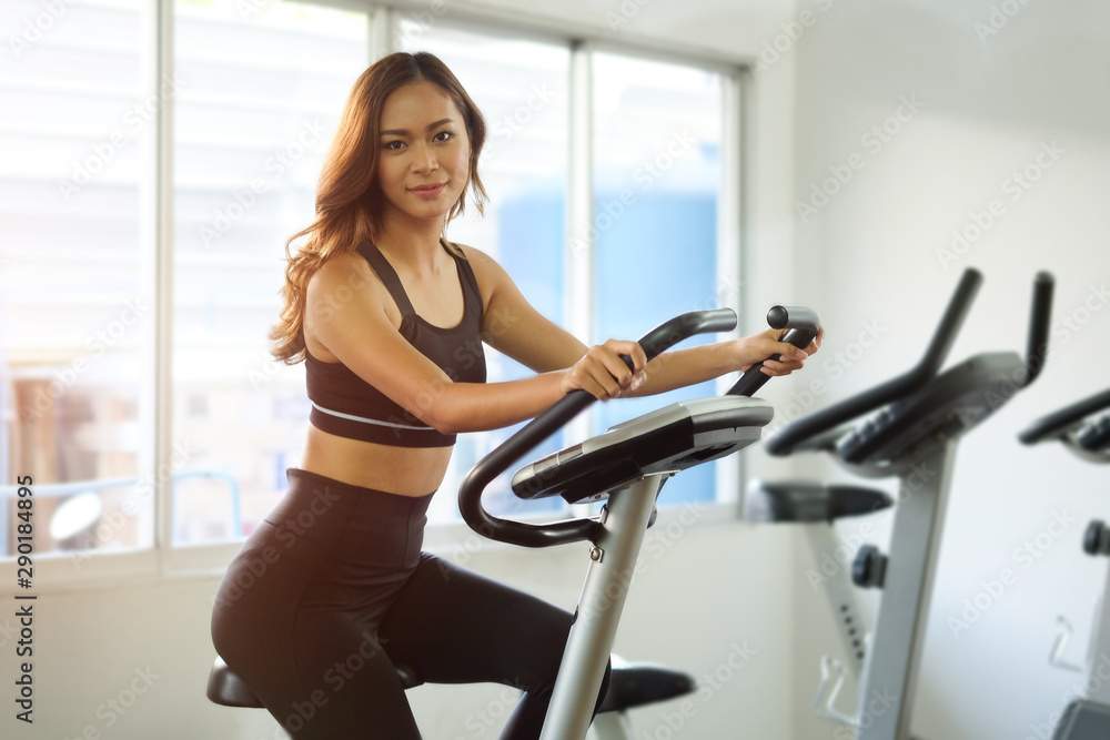 Women exercises warming up with weights in Gym health club in gym, concept Women exercises warming up with weights in Gym health club in gym, concept