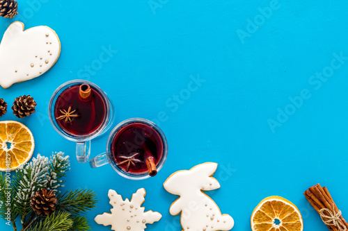 Romantic New Year with two glasses of mulled wine on blue background top view frame space for text