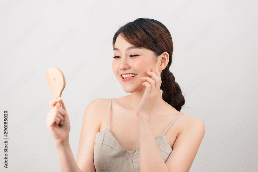 Young asian skin care woman smile and look mirror Young asian skin care woman smile and look mirror