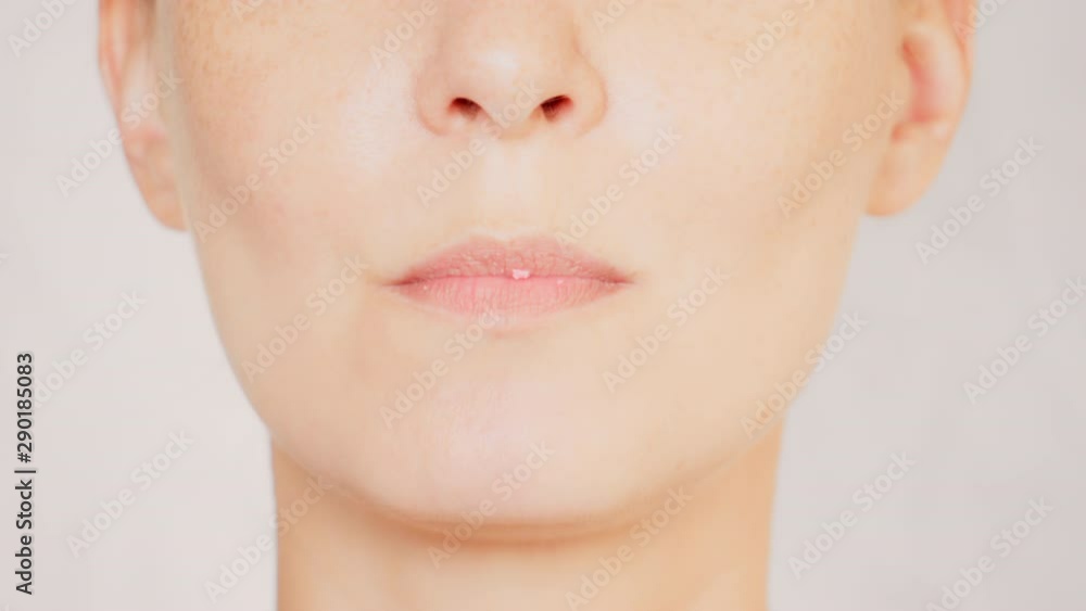 lower face caucasian female with freckles eats cookies cream portrait lady bites and chews lower face caucasian female with freckles eats cookies cream portrait lady bites and chews
