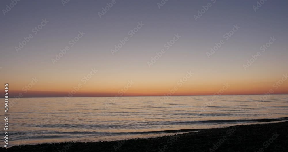 waves ripple on shore as sunlight fades on lake michigan waves ripple on shore as sunlight fades on lake michigan