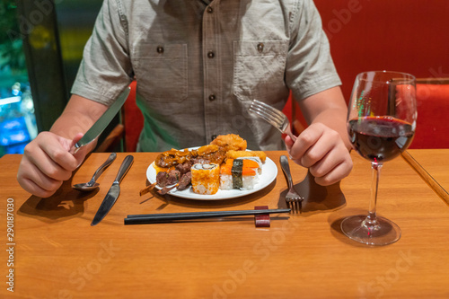 Human eating assortment of delicious food in luxury buffet meal