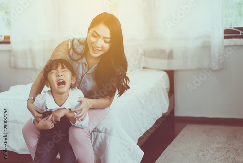 Asian single mom ticklish and carrying her cheerful daughter at home,Happy and funny