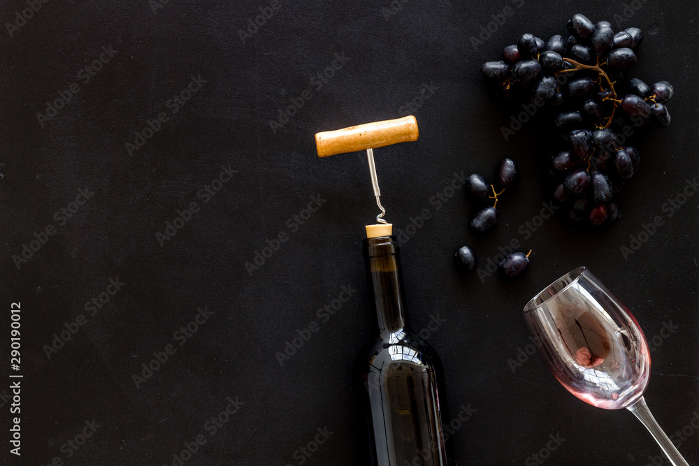 Composition with wine bottle on black background top view copy space Composition with wine bottle on black background top view copy space