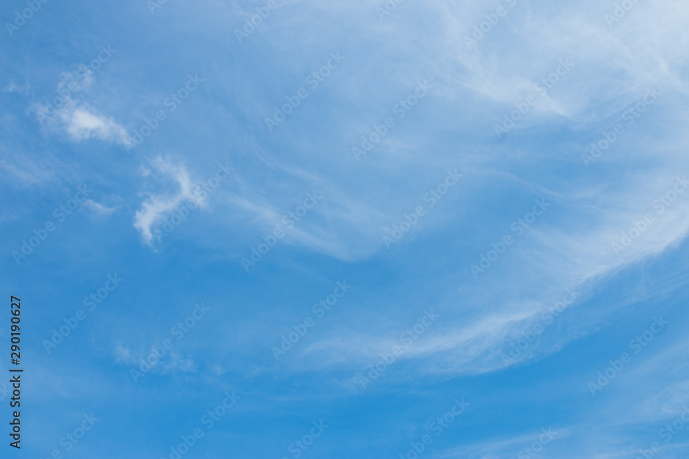Bright blue sky with white soft motion clouds