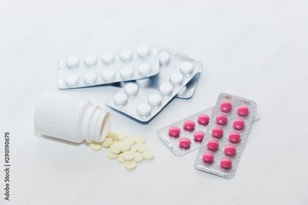 The medicine. Prevention of colds and flu. Multi-colored pills for treatment on a white background. Top view. Flat lay on a medical theme. The medicine. Prevention of colds and flu. Multi-colored pills for treatment on a white background. Top view. Flat lay on a medical theme.