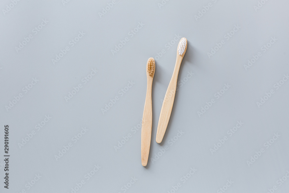eco natural bamboo toothbrushes flat lay on gray background. sustainable lifestyle concept. zero waste, plastic free items. stop plastic pollution. Top view, overhead, template, Mockup. eco natural bamboo toothbrushes flat lay on gray background. sustainable lifestyle concept. zero waste, plastic free items. stop plastic pollution. Top view, overhead, template, Mockup.