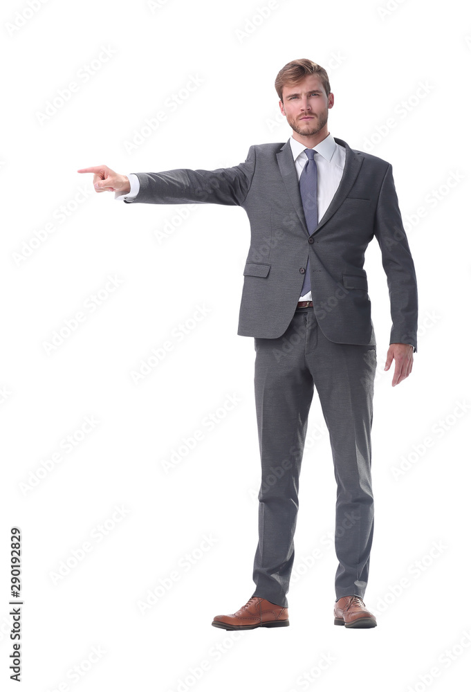 in full growth. serious businessman pointing to the side. in full growth. serious businessman pointing to the side.