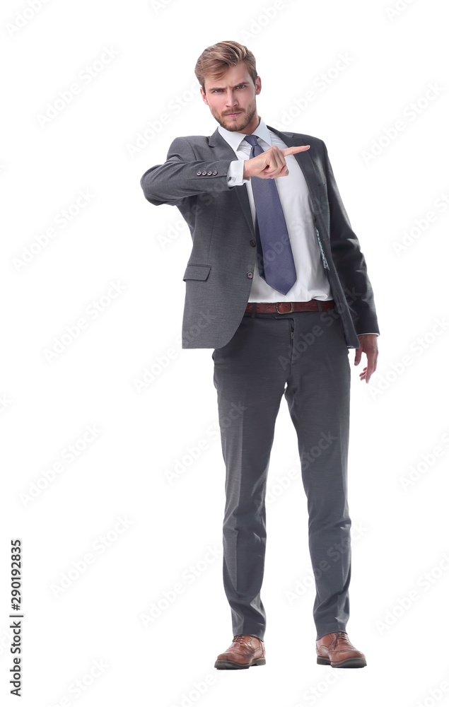in full growth. serious businessman pointing to the side. in full growth. serious businessman pointing to the side.