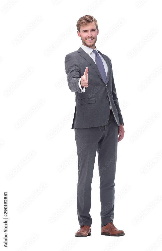 in full growth. smiling businessman holding out his hand for a handshake. in full growth. smiling businessman holding out his hand for a handshake.