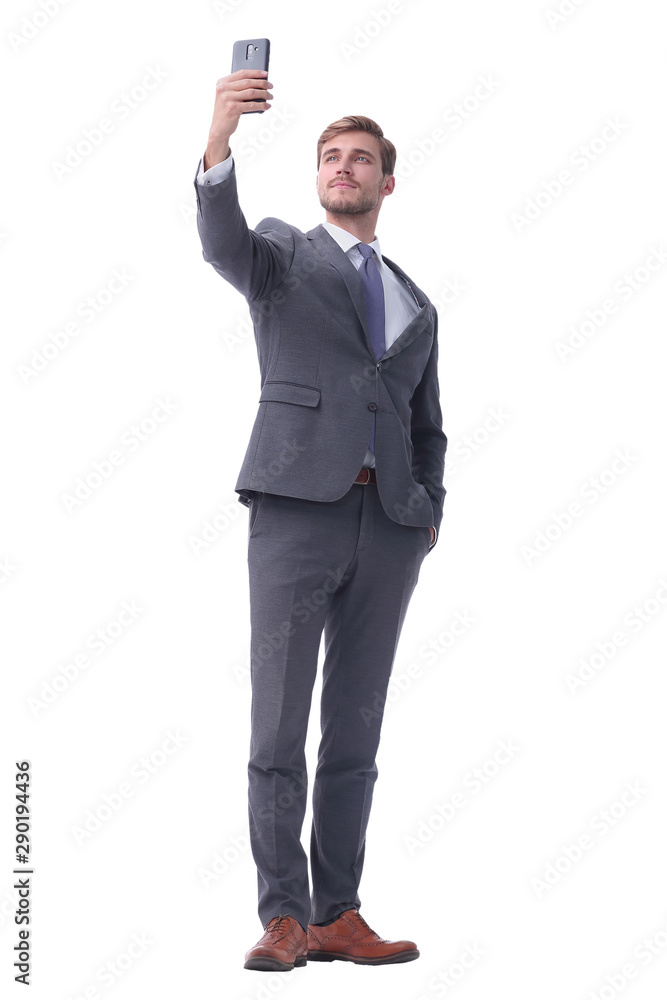 in full growth. smiling businessman taking selfie. in full growth. smiling businessman taking selfie.