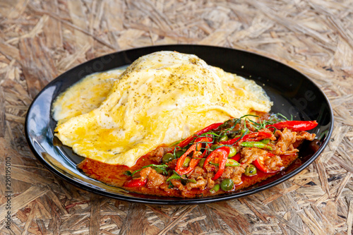 Creamy Omelet with hot and spicy beef panang curry on jusmine Rice photo