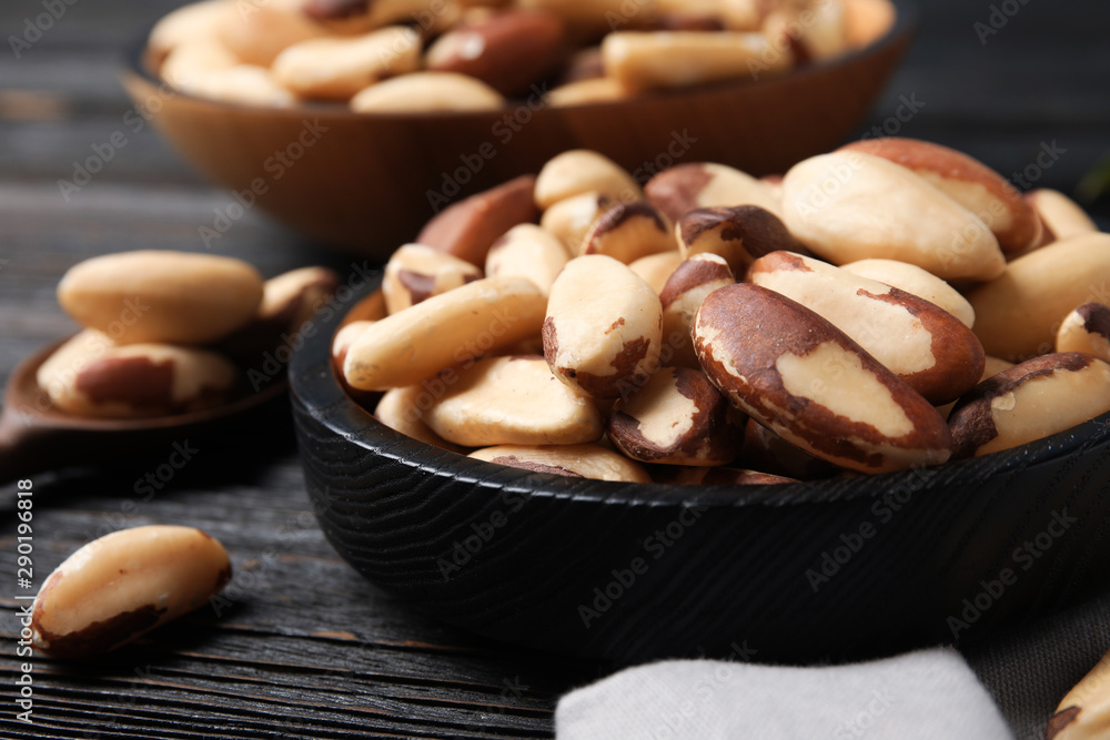 Fototapeta premium Plate with tasty Brazil nuts on wooden table